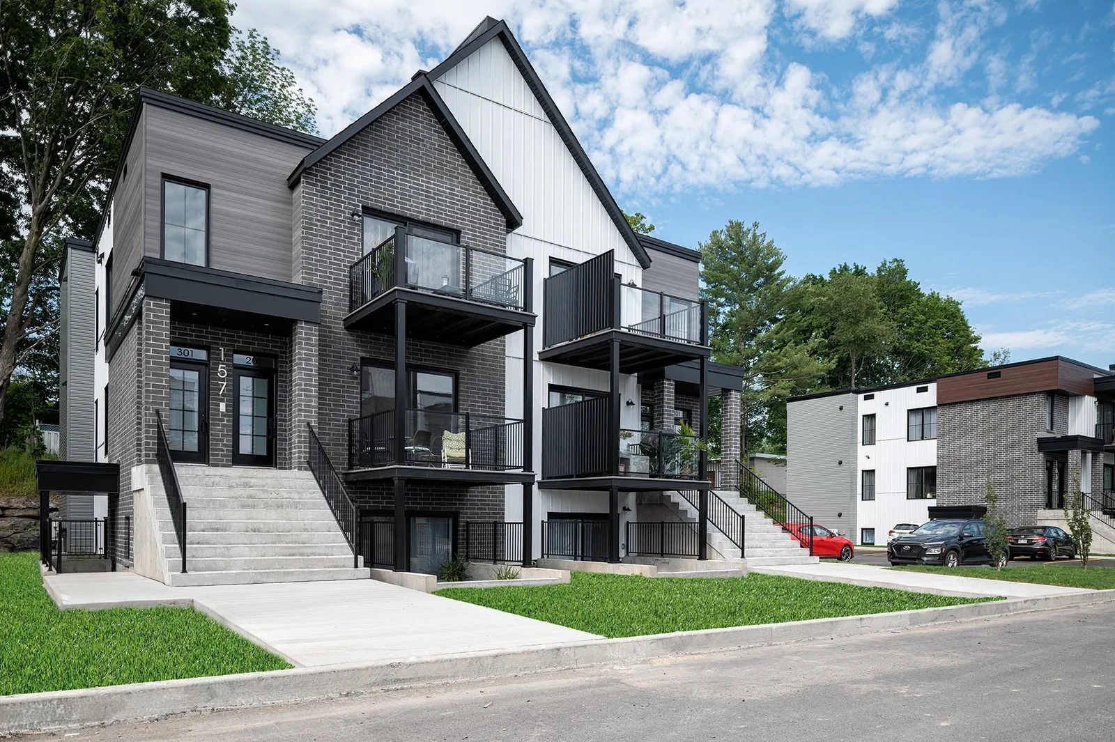 Immeuble résidentiel avec balcons noirs et revêtement clair